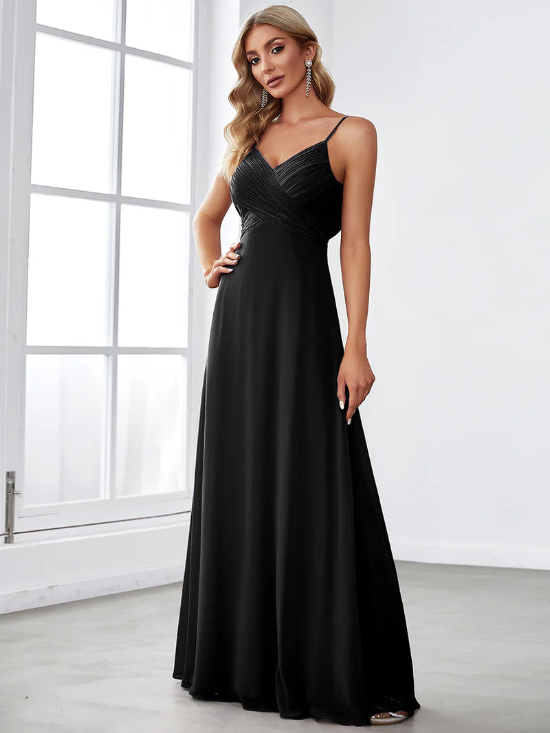 Sleeveless black bridesmaid dress with spaghetti straps.