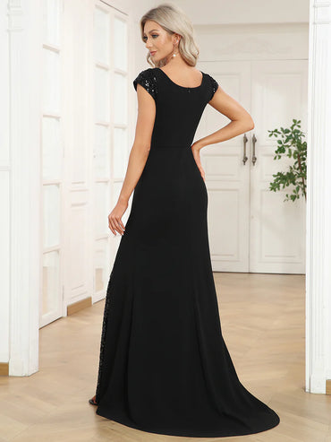 Black formal or evening dress with cap sleeves, lace and sequin insert with mermaid tail.