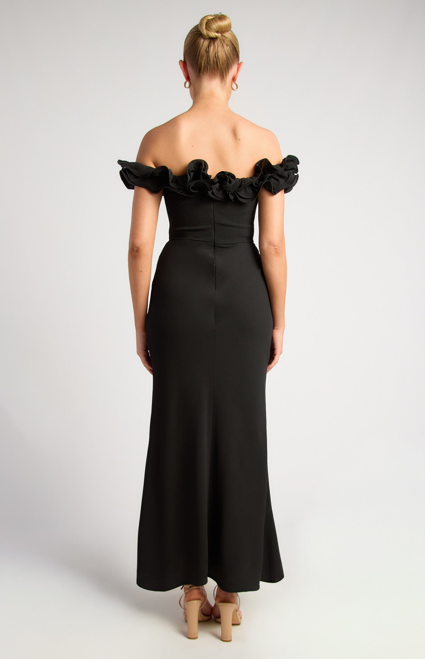 Black formal dress with ruffle neck and off shoulder sleeve.