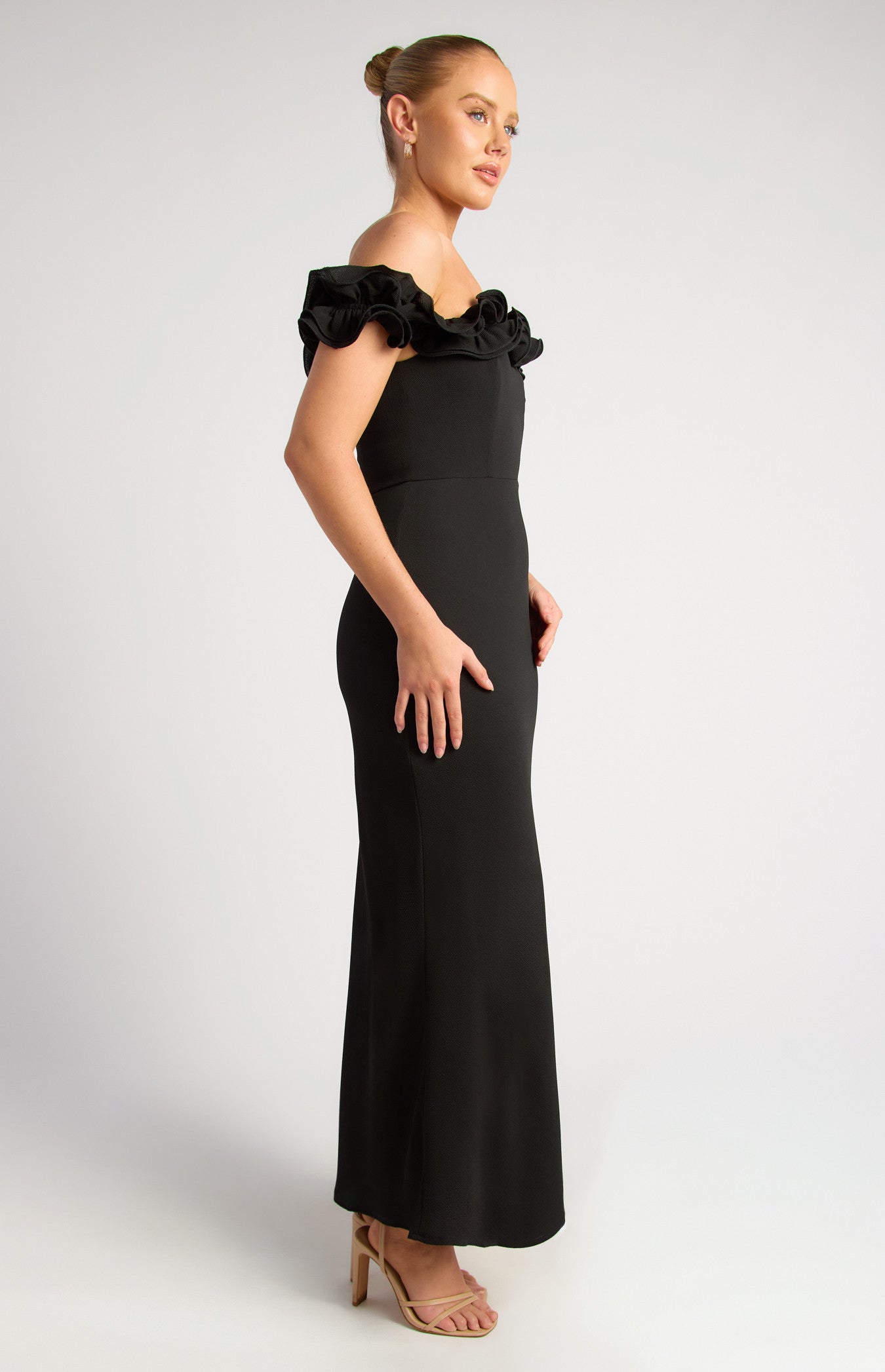 Black formal dress with ruffle neck and off shoulder sleeve.