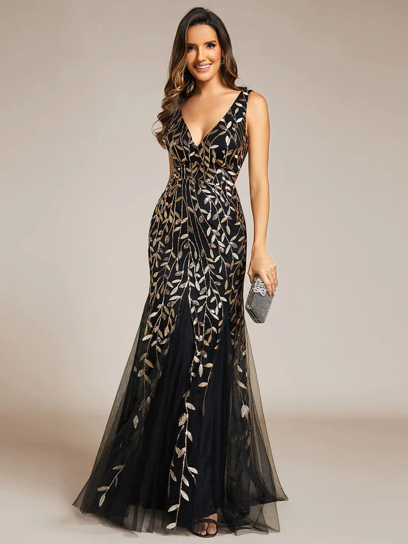 Black and gold formal dress with fishtail and sequins.