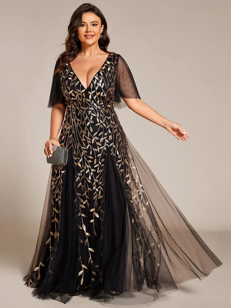Black and Gold plus size mother of the bride dress with short sleeves and flowing tulle.