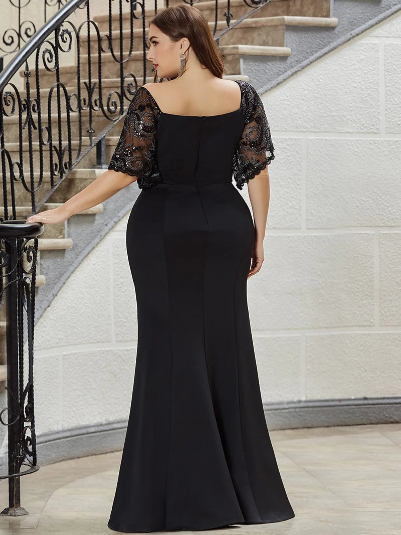 Black Plus size formal, mother of the bride, evening dress with lace sleeves, v-neck and fishtail.