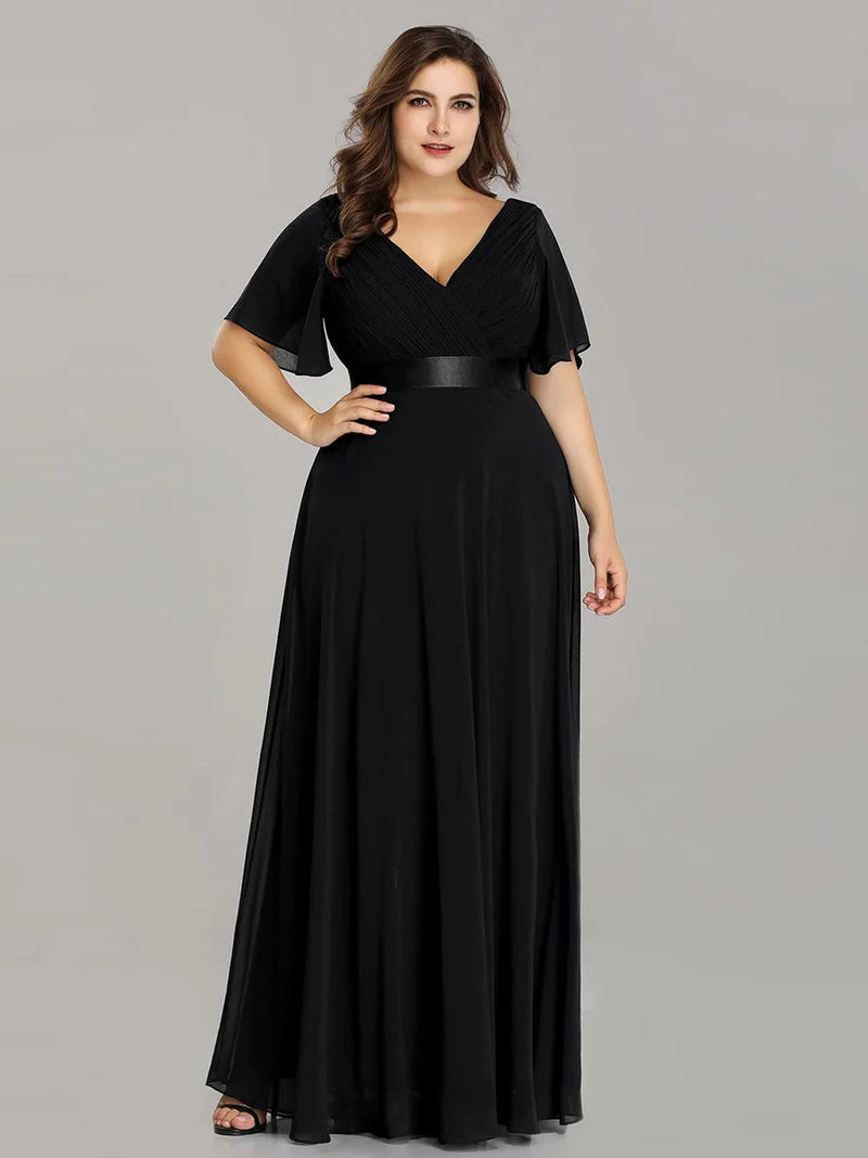 Black plus size mother of the bride dress in chiffon with short sleeves and a satin band.