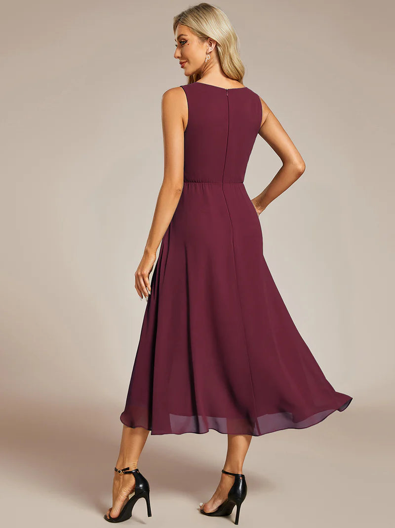 Burgundy cocktail formal dress in chiffon with applique detail and sleeveless.