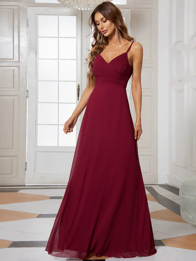Sleeveless burgundy red bridesmaid dress with spaghetti straps.