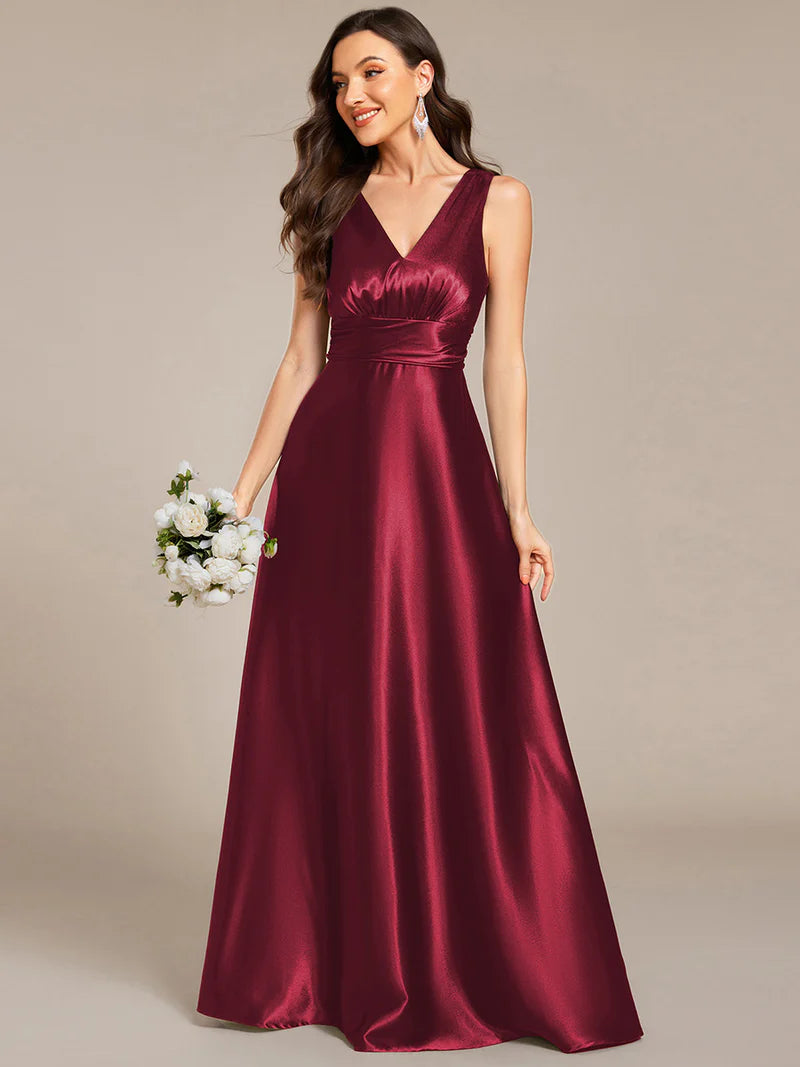 Burgundy red satin bridesmaid dress with v-neck and pockets.