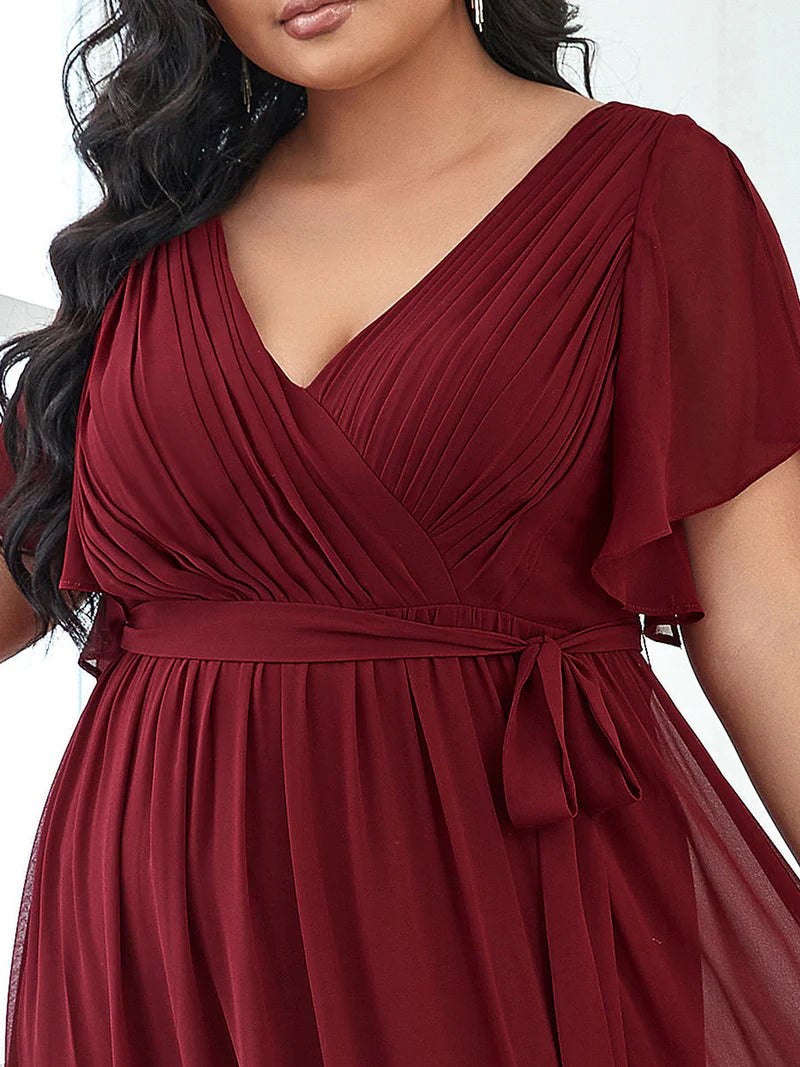 Burgundy-red plus sized bridesmaid dress with v-neck and a-line.
