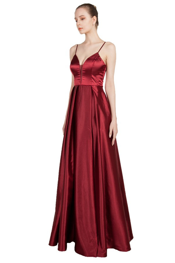 Burgundy satin formal dress with spaghetti straps and pockets.