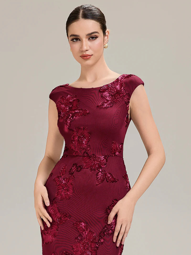 Burgundy mother of the bride dress with ribbon detail and sheath mermaid style.