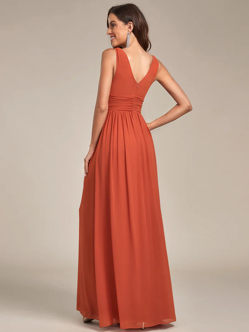 Burnt orange bridesmaid dress with double v-neck and chiffon.