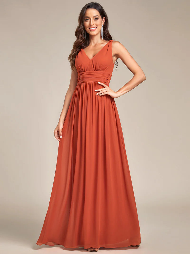 Burnt orange bridesmaid dress with double v-neck and chiffon.