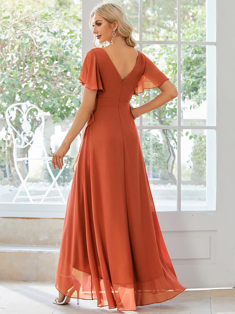 Burnt orange bridesmaid dress with high low ruffle and chiffon.