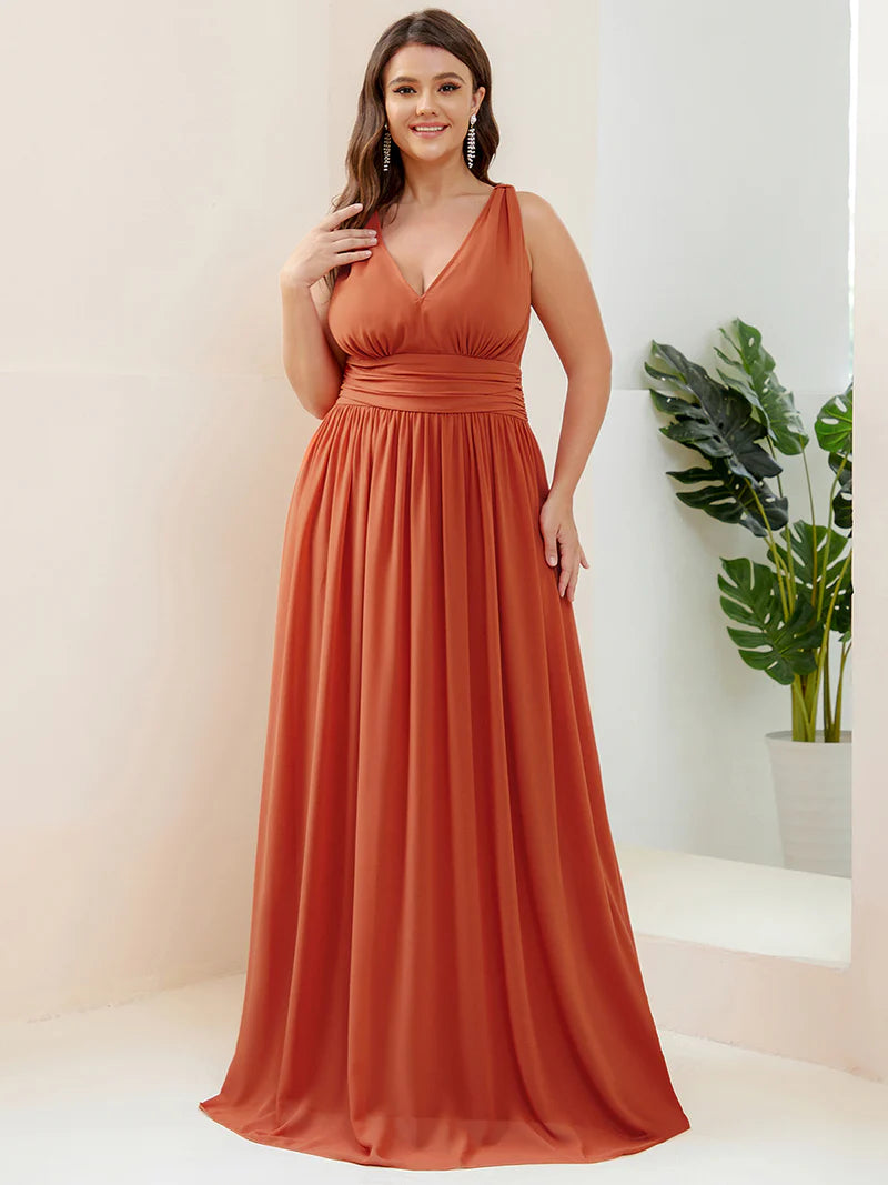 Burnt orange plus sized bridesmaid dress with double v-neck and chiffon.