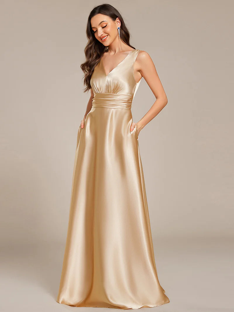 Champagne satin bridesmaid dress with v-neck and pockets.