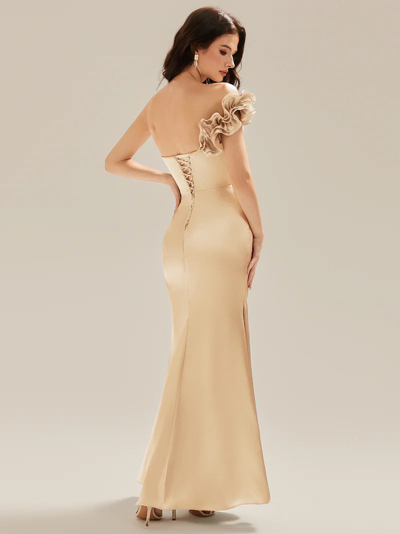 Champagne strapless formal dress with fishtail and ruffles.