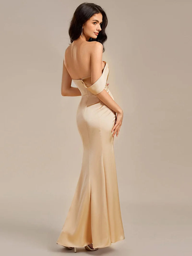 Champagne satin formal dress or bridesmaid dress in an off shoulder design with a split.
