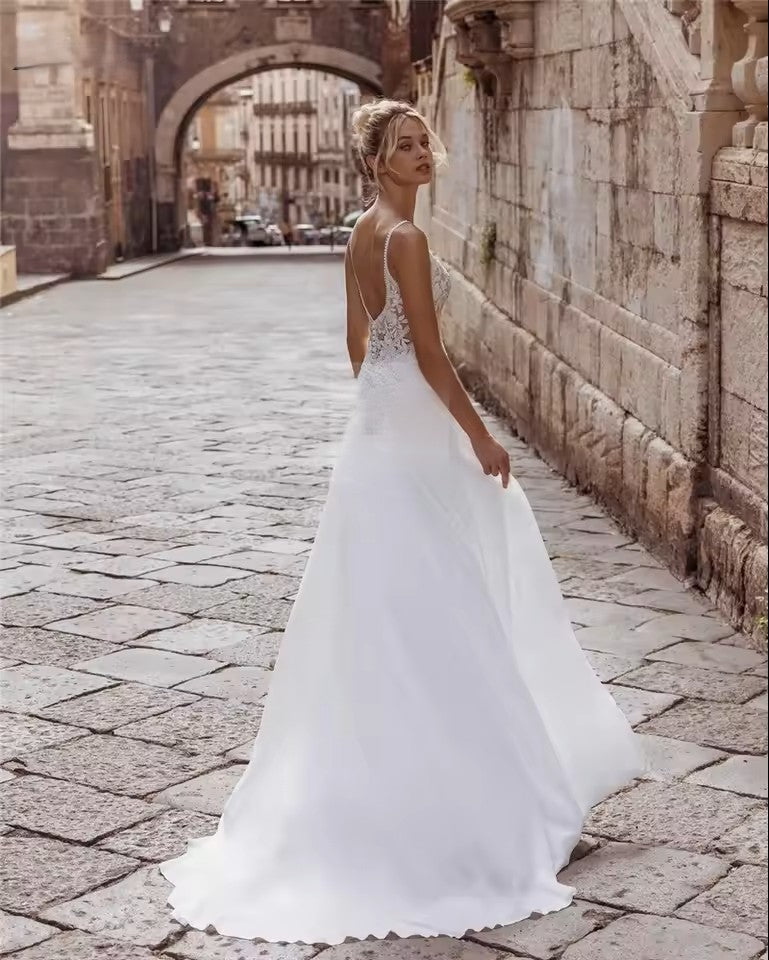 Chiffon wedding dress with lace bodice, spaghetti straps and button detail on the back.
