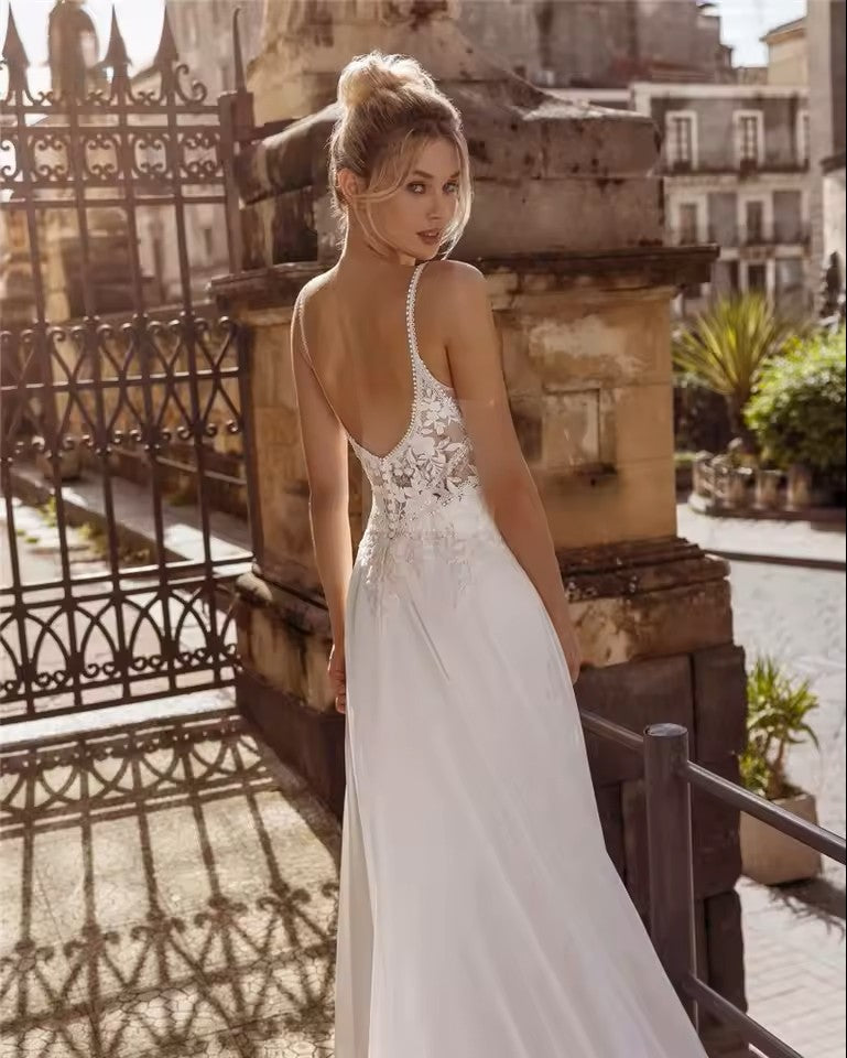 Chiffon wedding dress with lace bodice, spaghetti straps and button detail on the back.