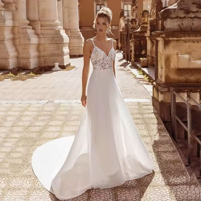 Chiffon wedding dress with lace bodice, spaghetti straps and button detail on the back.
