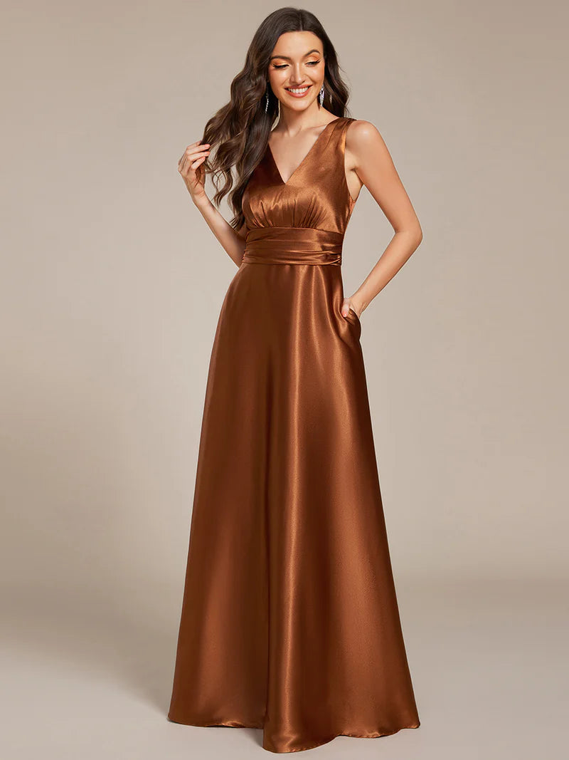 Copper satin bridesmaid dress with v-neck and pockets.