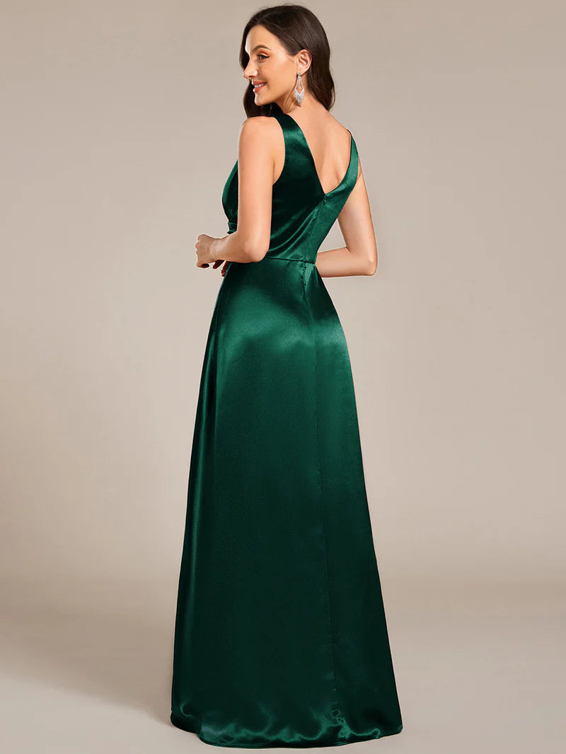 Dark green satin bridesmaid dress with v-neck and pockets.