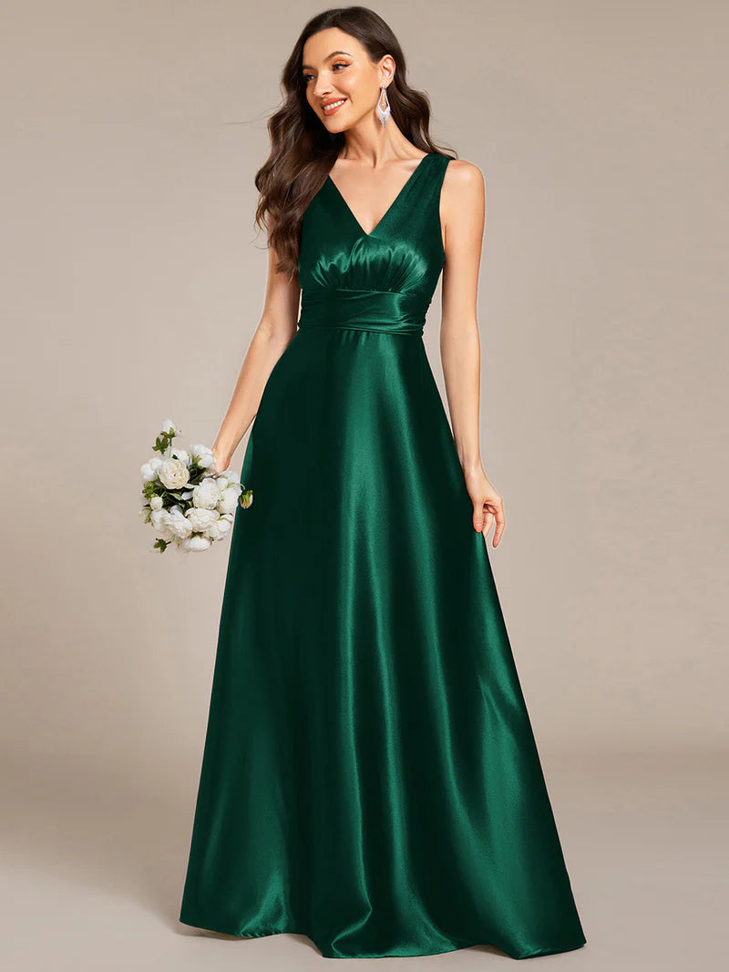 Dark green satin bridesmaid dress with v-neck and pockets.