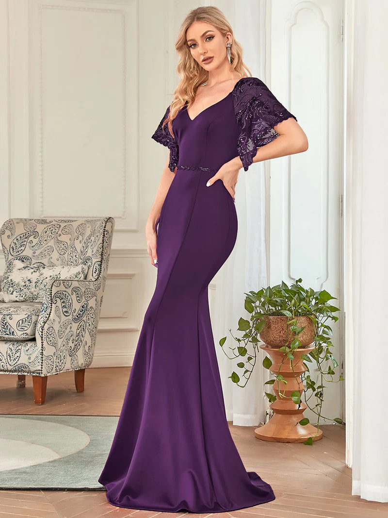 Deep purple mother of the bride dress with lace sleeves, v-neck and fishtail.