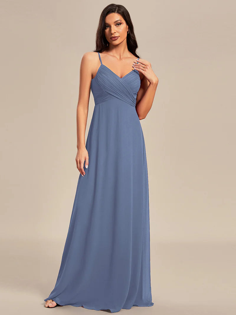Sleeveless dusty blue bridesmaid dress with spaghetti straps.