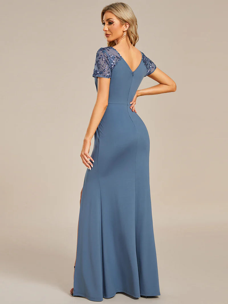 An elegant mother of the bride long dusty blue applique cap sleeved formal or evening dress, ruched at the middle.