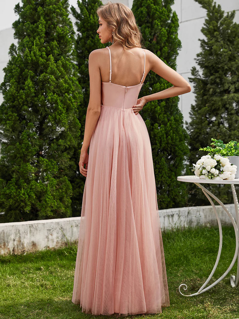 Dusty pink formal tulle dress with beaded pearl top and spaghetti straps.