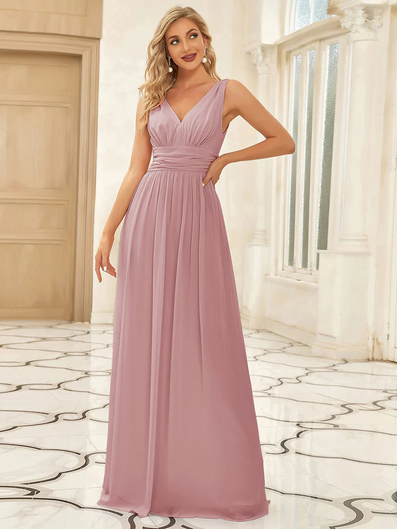 Dusty rose bridesmaid dress with double v-neck and chiffon.