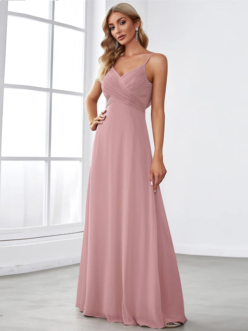Sleeveless dusty rose bridesmaid dress with spaghetti straps.