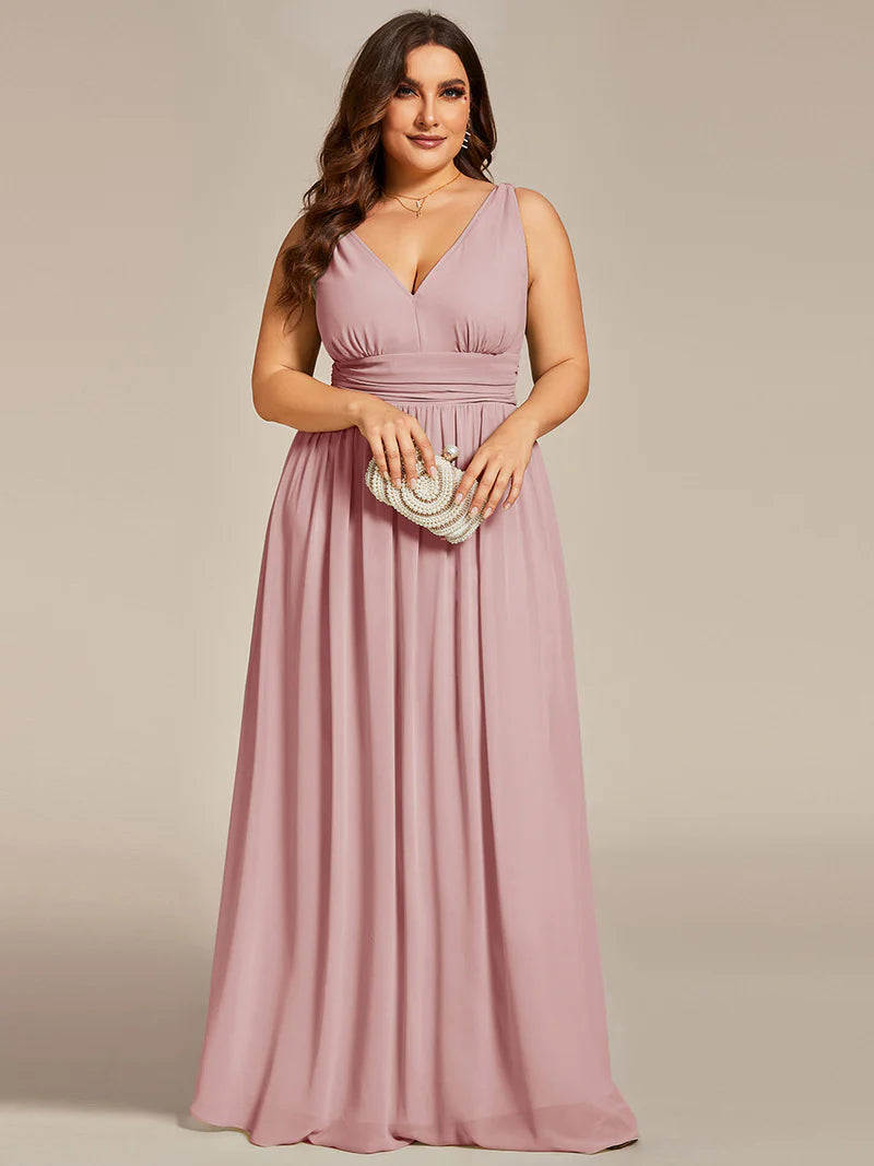 Dusty rose plus sized bridesmaid dress with double v-neck and chiffon.