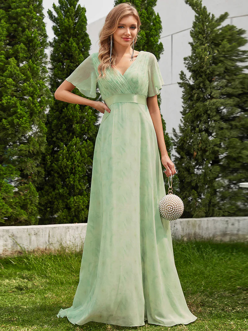 Floral green formal dress in chiffon with satin band and short sleeves.