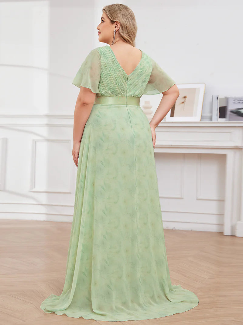 Floral green plus size mother of the bride dress in chiffon with short sleeves and a satin band.
