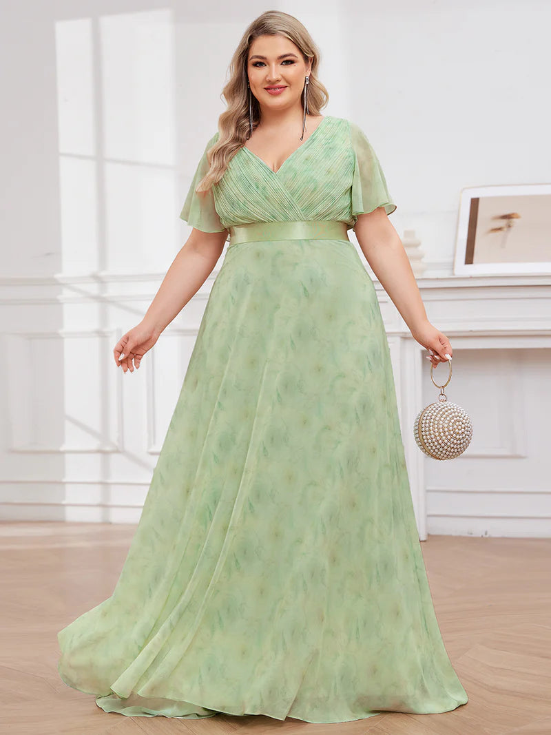 Floral green plus size mother of the bride dress in chiffon with short sleeves and a satin band.