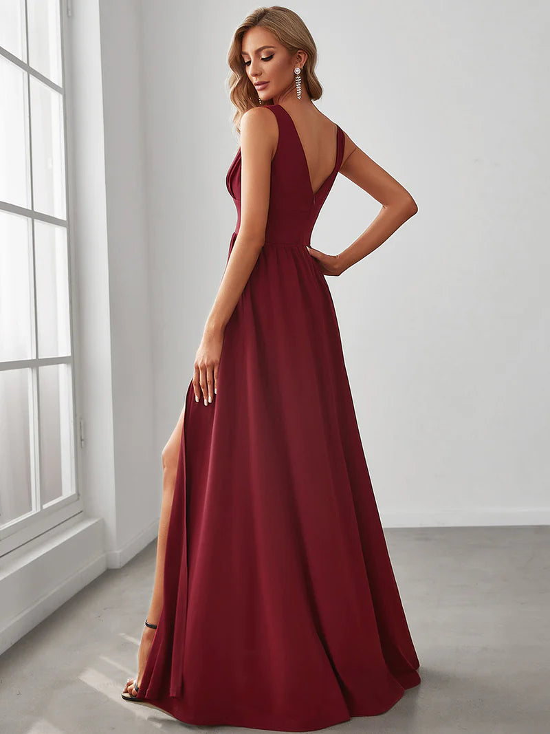Burgundy red sleeveless formal dress with deep v neck and front split.