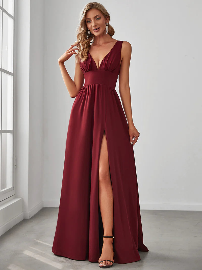 Burgundy red sleeveless formal dress with deep v neck and front split.