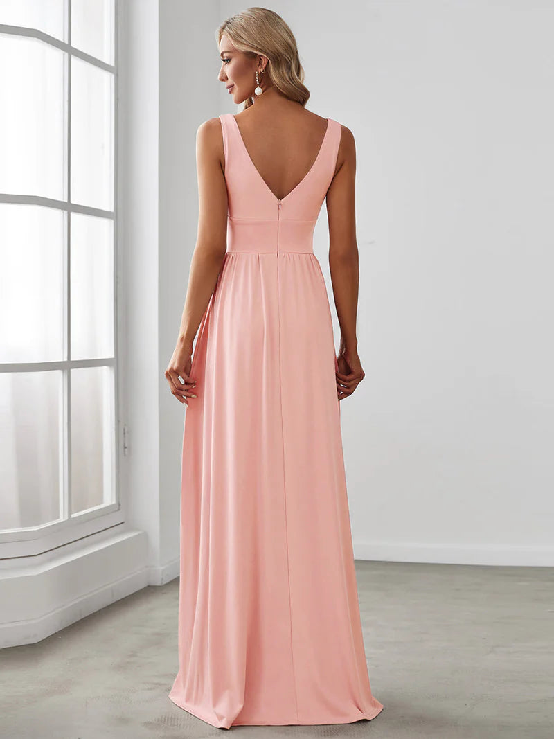 Pink sleeveless formal dress with deep v neck and front split.