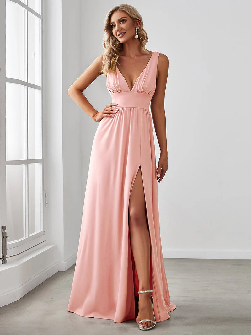 Pink sleeveless formal dress with deep v neck and front split.
