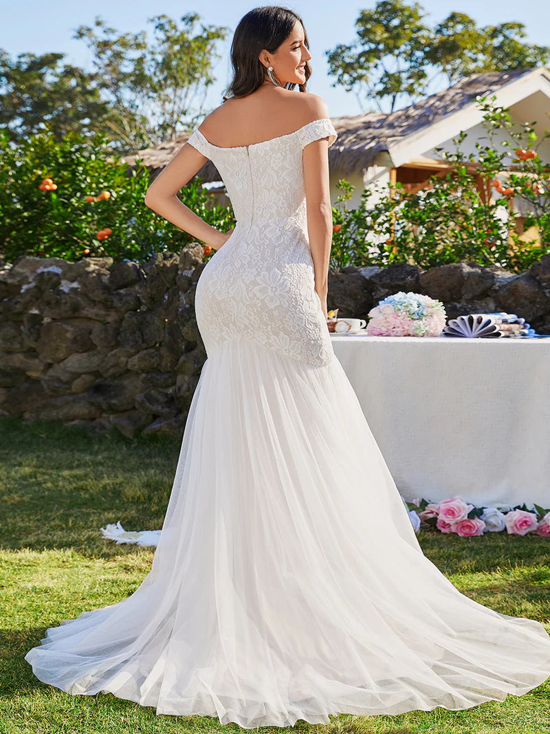 Ivory lace and tulle wedding dress with off the shoulder sleeve. Plus size available.