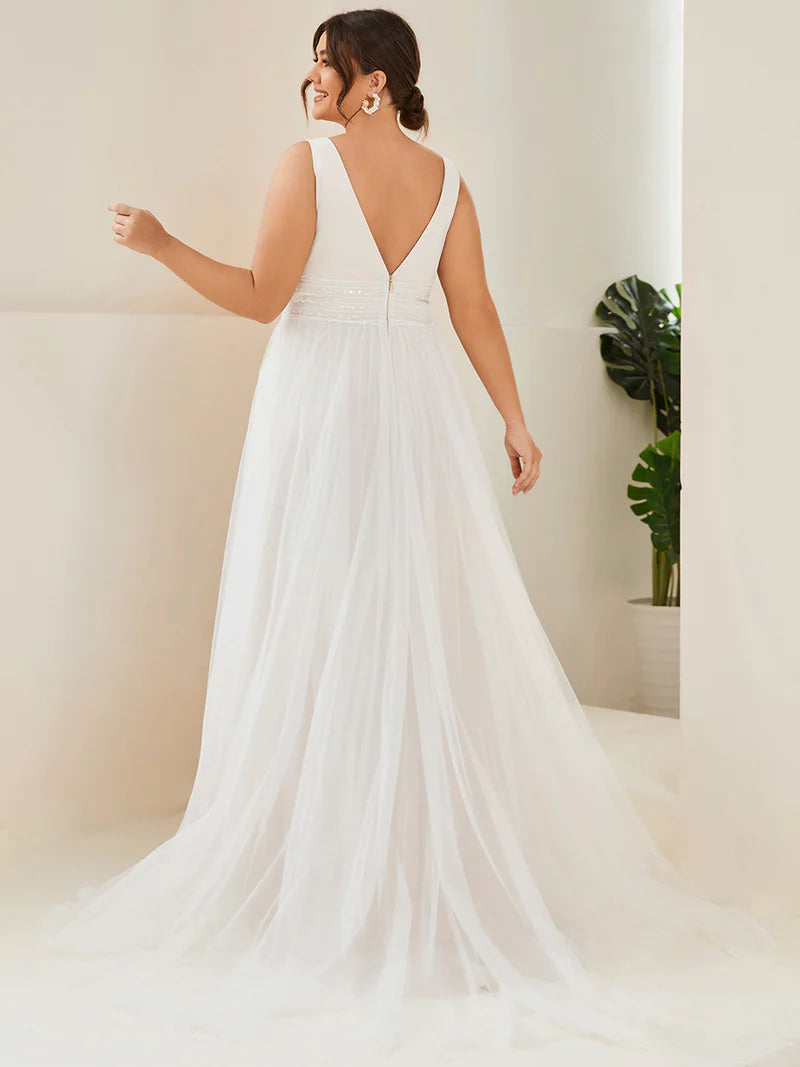 Ivory plus size wedding dress with deep v neck tulle skirt beaded detail.
