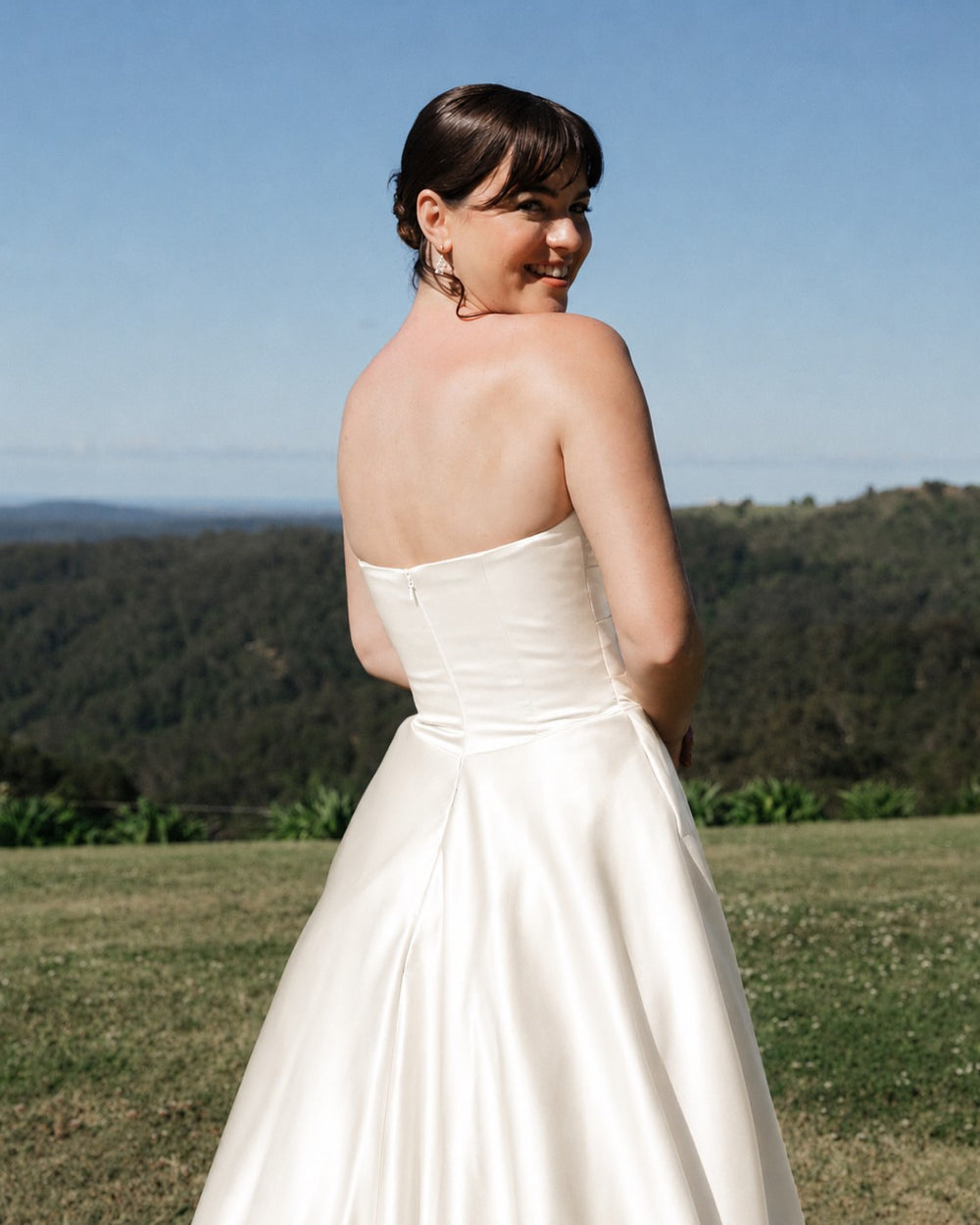 Ivory satin strapless wedding dress by Drew Valentine.