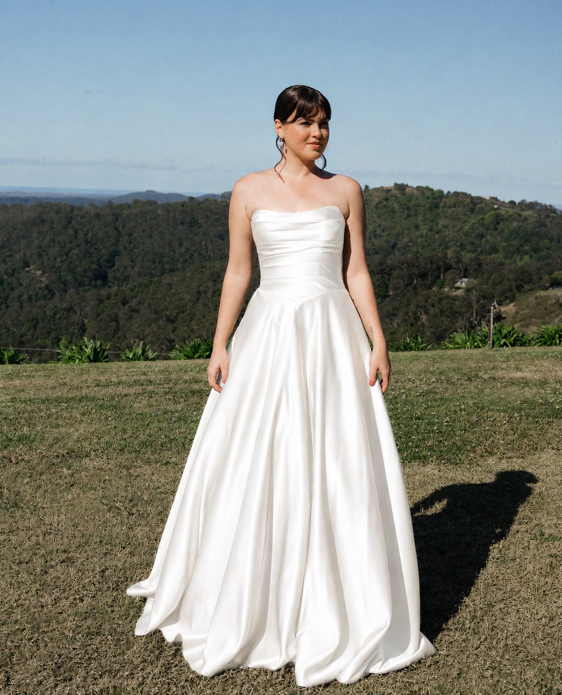 Ivory satin strapless wedding dress by Drew Valentine.