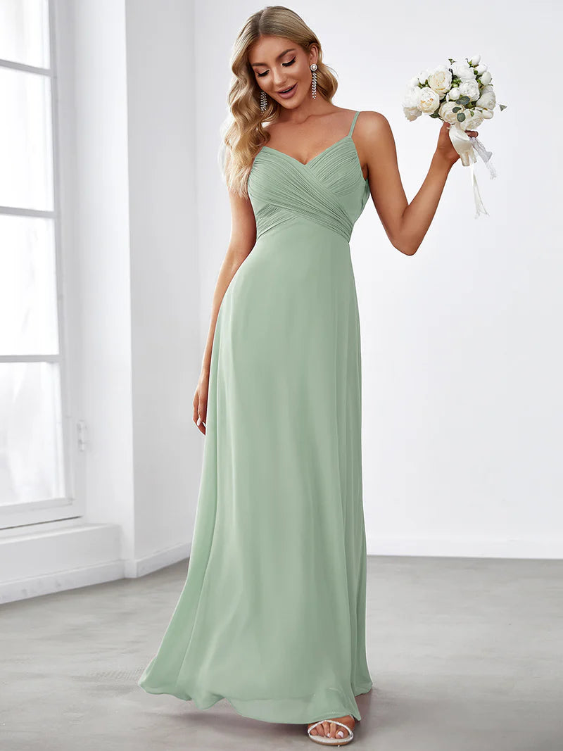 Sleeveless mint green bridesmaid dress with spaghetti straps.