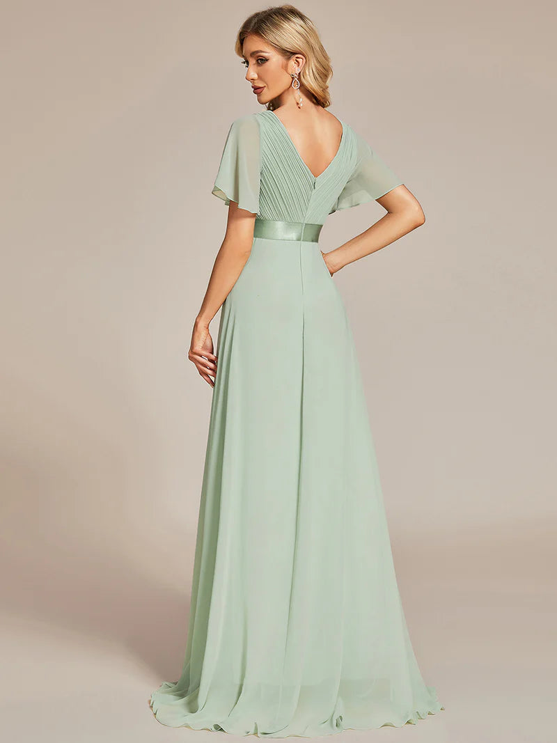 Mint green formal dress in chiffon with satin band and short sleeves.