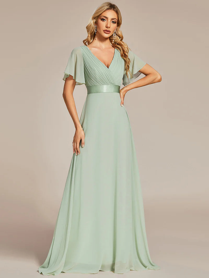 Mint green formal dress in chiffon with satin band and short sleeves.