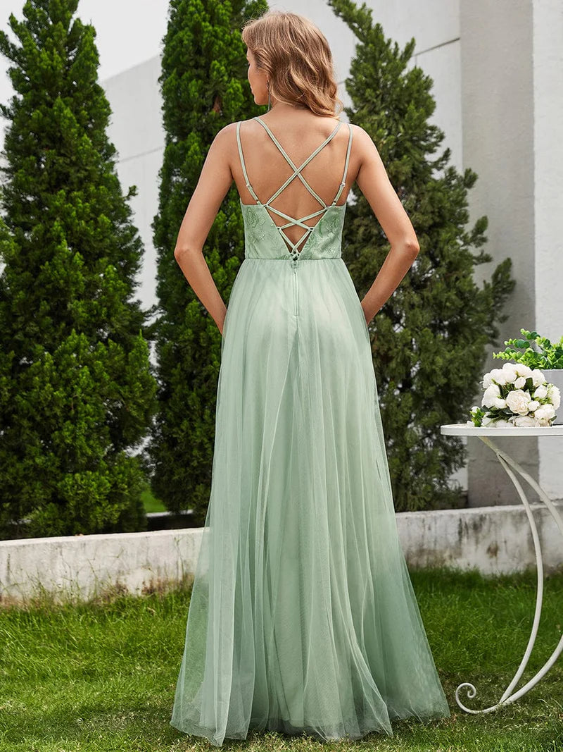 Mint green formal dress with spaghetti straps, lace up back and tulle skirt.
