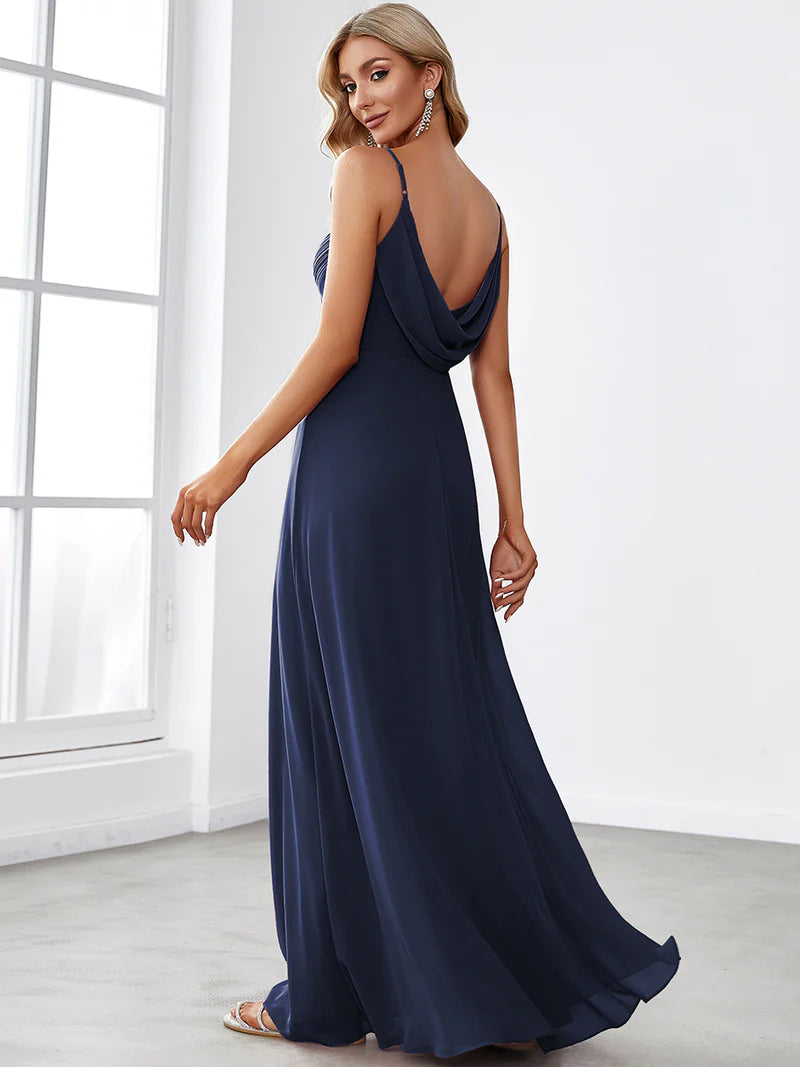 Sleeveless navy blue bridesmaid dress with spaghetti straps.